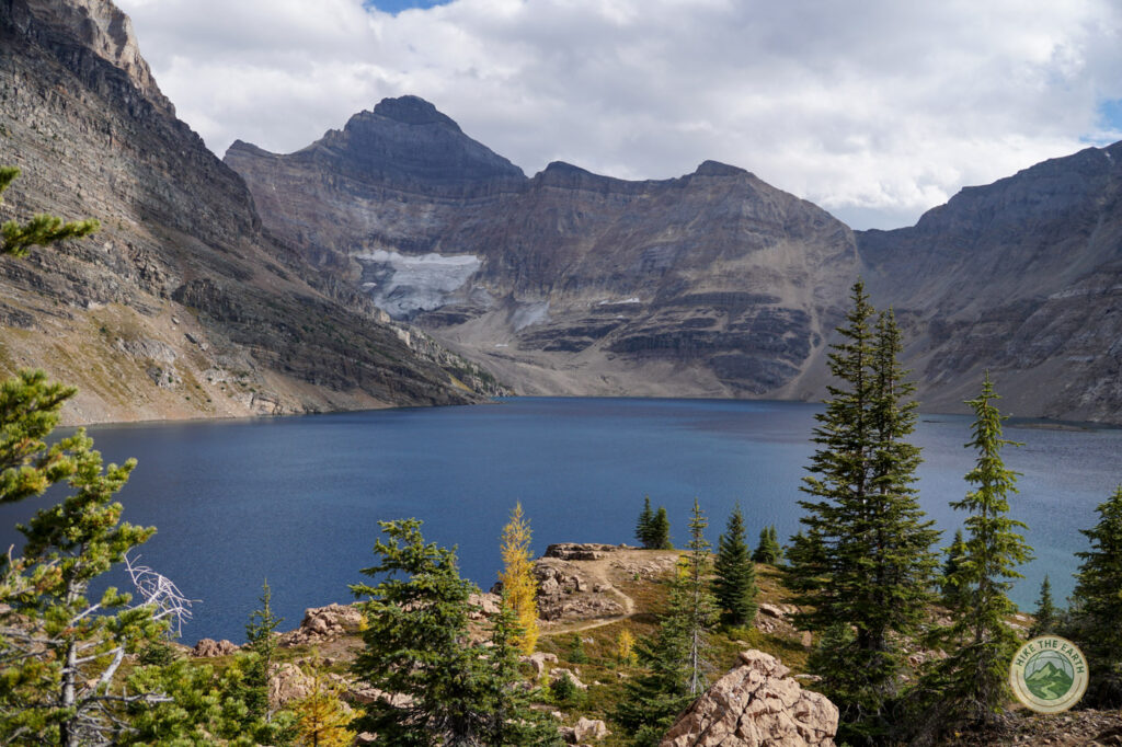Lake McArthur with deep blue water and mountain backdrop during larch season in Yoho National Park 