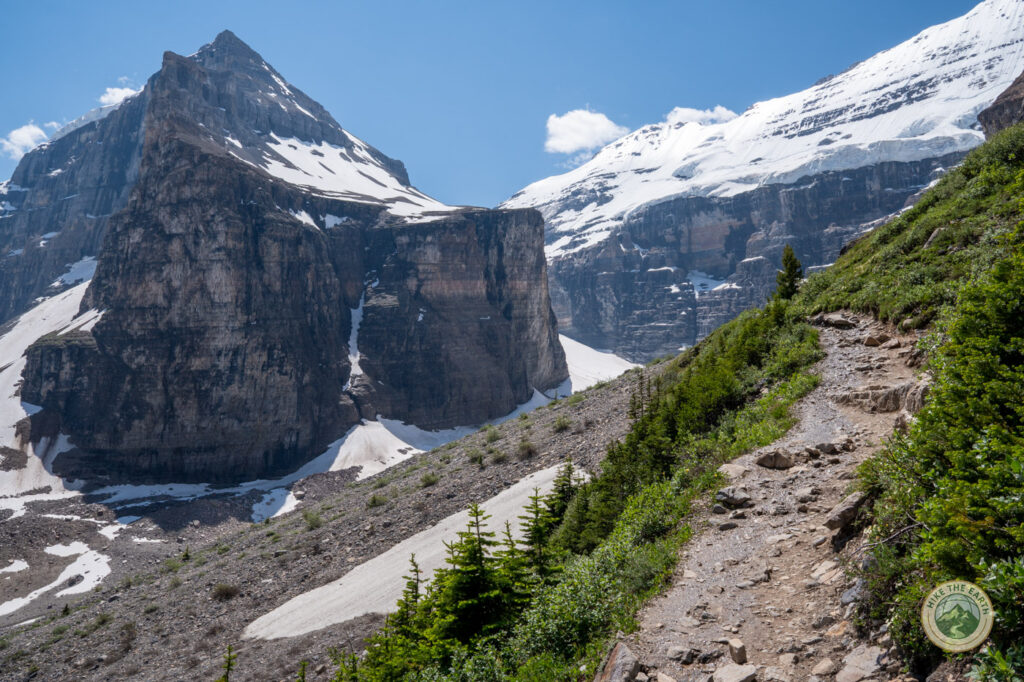 Trail hugging the hillside on the Plain of Six Glaciers hike with glacier and mountain views