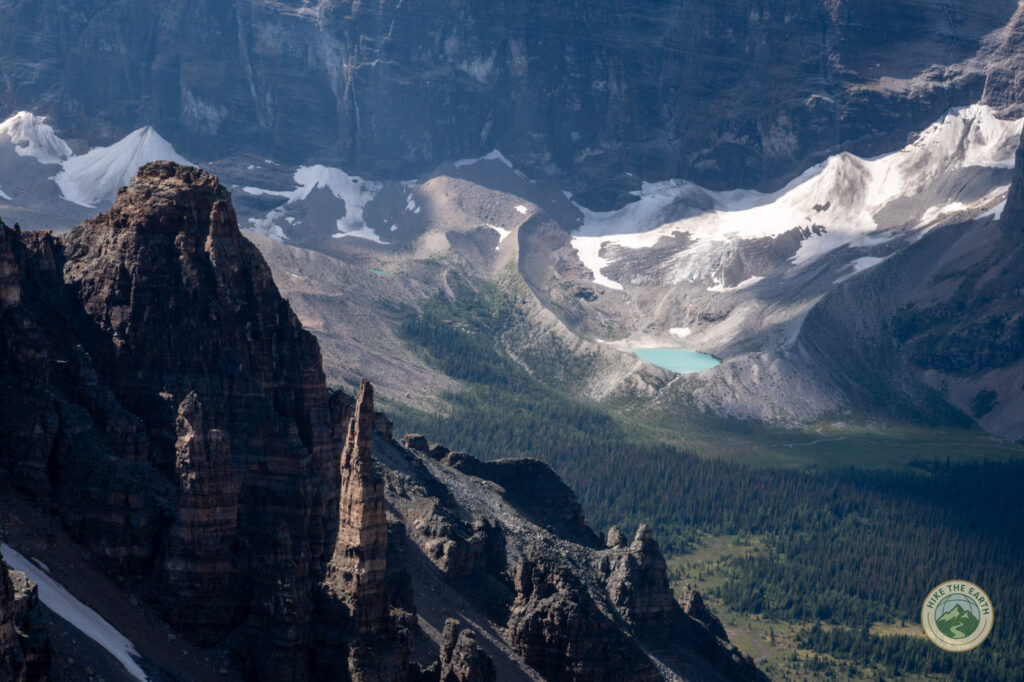 Rock spires and glacier lake views on the descent from Mount Temple